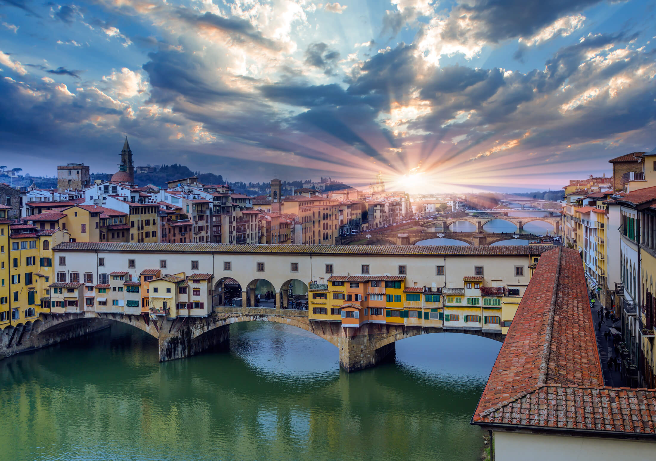 Solen over Ponte Vecchio i Firenze, Italien